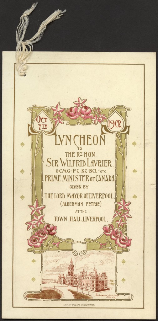 Texte centré, encadré avec soin de lignes dorées et fluides rappelant des tiges de roses, de roses de couleur rose et de feuilles dans les coins inférieurs; sous le cadre, reproduction des édifices du Parlement à Ottawa. 