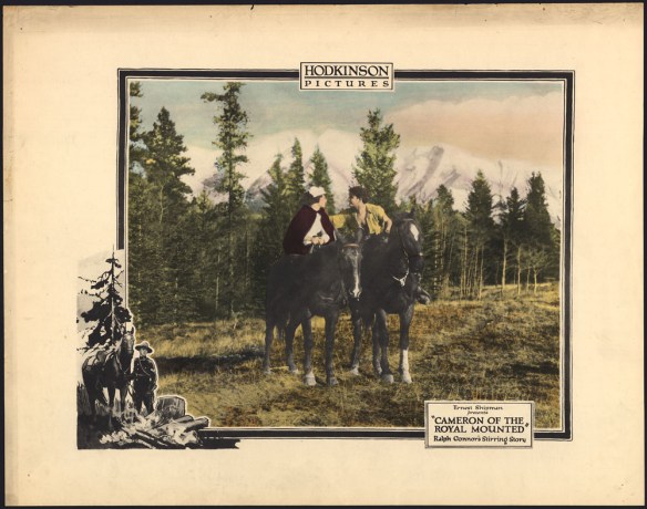 Image en couleurs d’un homme et d’une femme à cheval dans une clairière, devant des arbres verts majestueux et des montagnes aux cimes enneigées. L’homme porte une chemise jaune déboutonnée pour exposer sa poitrine. Il est penché vers la femme qui porte un bonnet blanc et une mante rouge. Découpée et apposée en bas à gauche, une autre image, en noir et blanc, illustre un gendarme en uniforme qui dirige son cheval vers un feu de camp; un grand arbre se dresse en arrière-plan. Le titre du film est écrit en bas à droite, sur l’affiche.